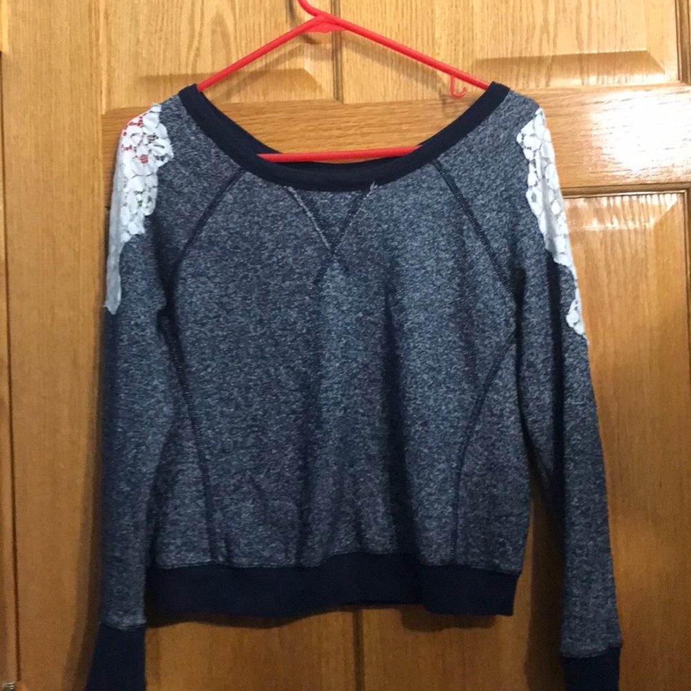 Blue sweater with white lace on the shoulders